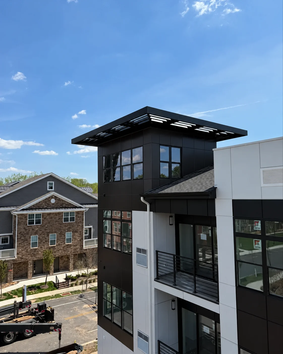 Finished black aluminum awning on a multifamily building exterior.